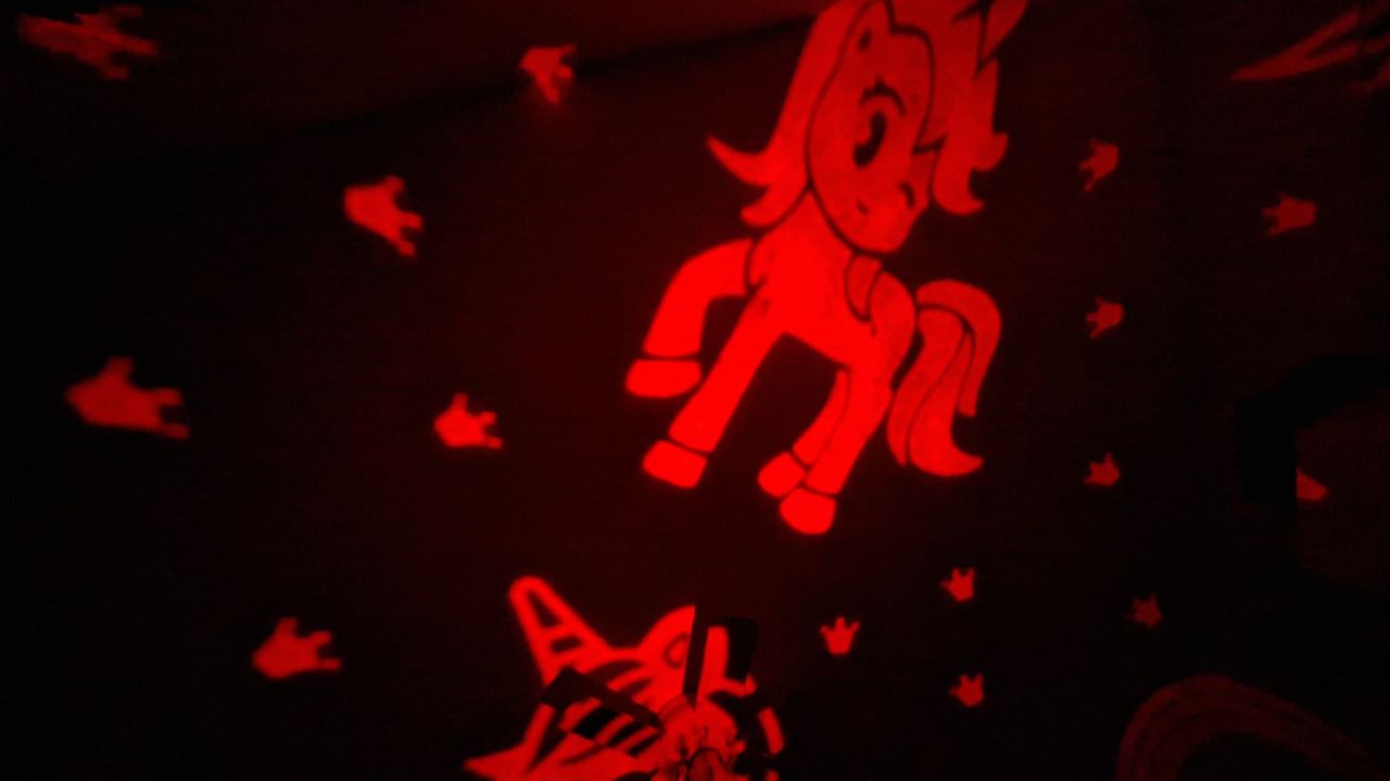 Projection of a red pony from the One Fire Star Projector