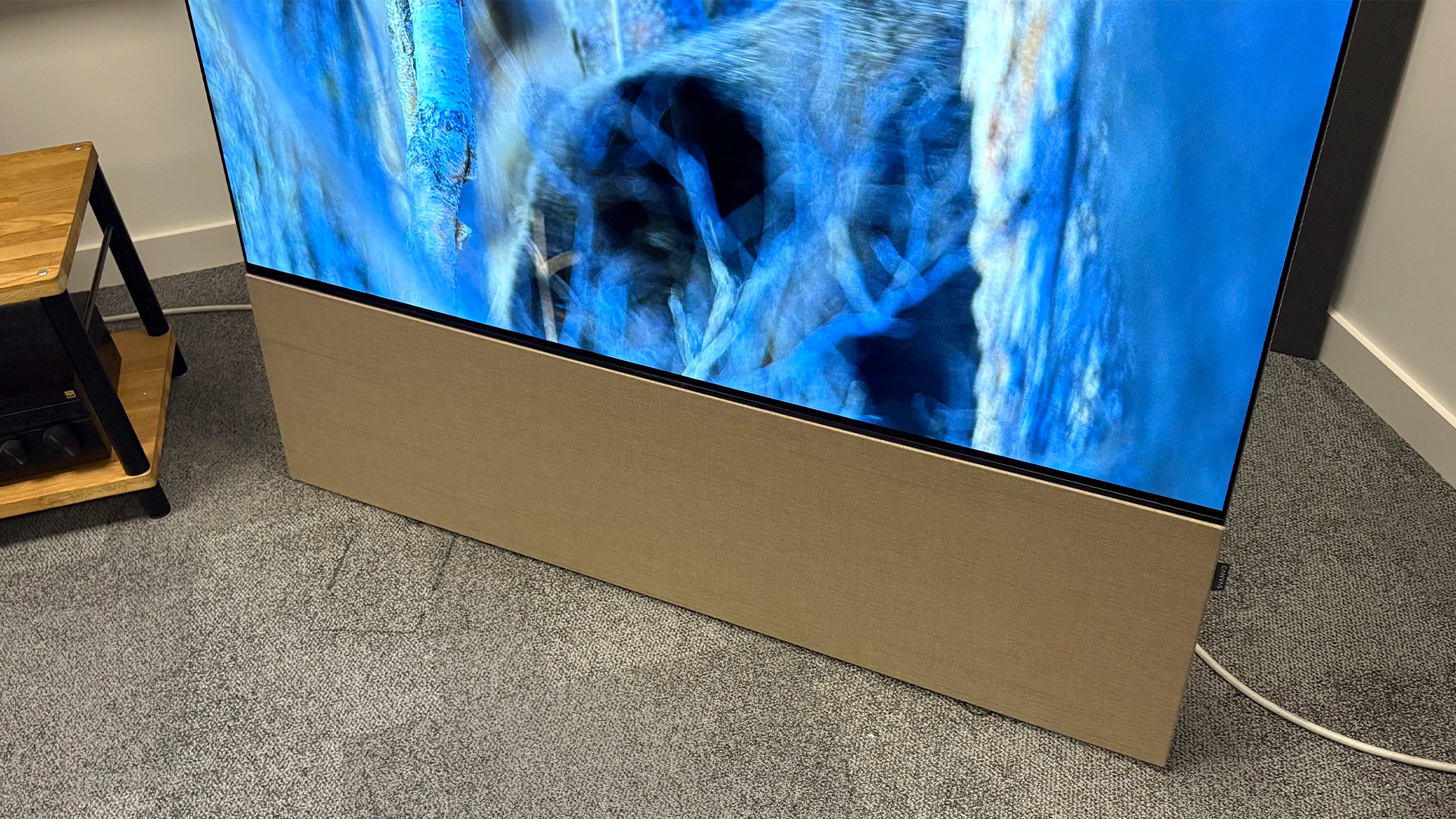 Canvas Hifi 65 soundbar with light oak panel attached and TV above