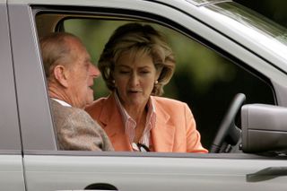 Prince Philip and Penny Knatchbull in a car together.