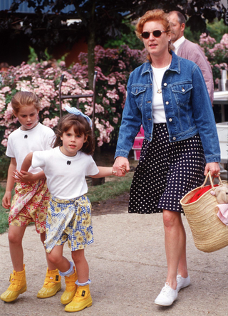 Sarah, Duchess Of York, With Princess Beatrice And Princess Eugenie Casually Dressed In Yellow "muckers" With Short Skirts And White T-shirts in 1996