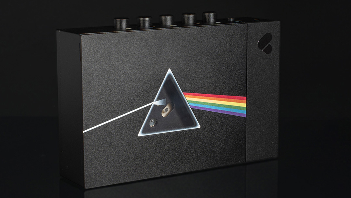 The Pink Floyd x We Are Rewind cassette player showing the Dark Side of the Moon album logo on the front, with a triangular window where the prism would be