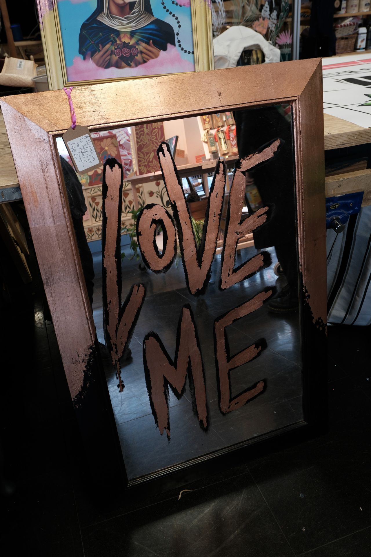 A photo of a mirror with "Love Me" written on it, taken on a Fujifilm X-M5