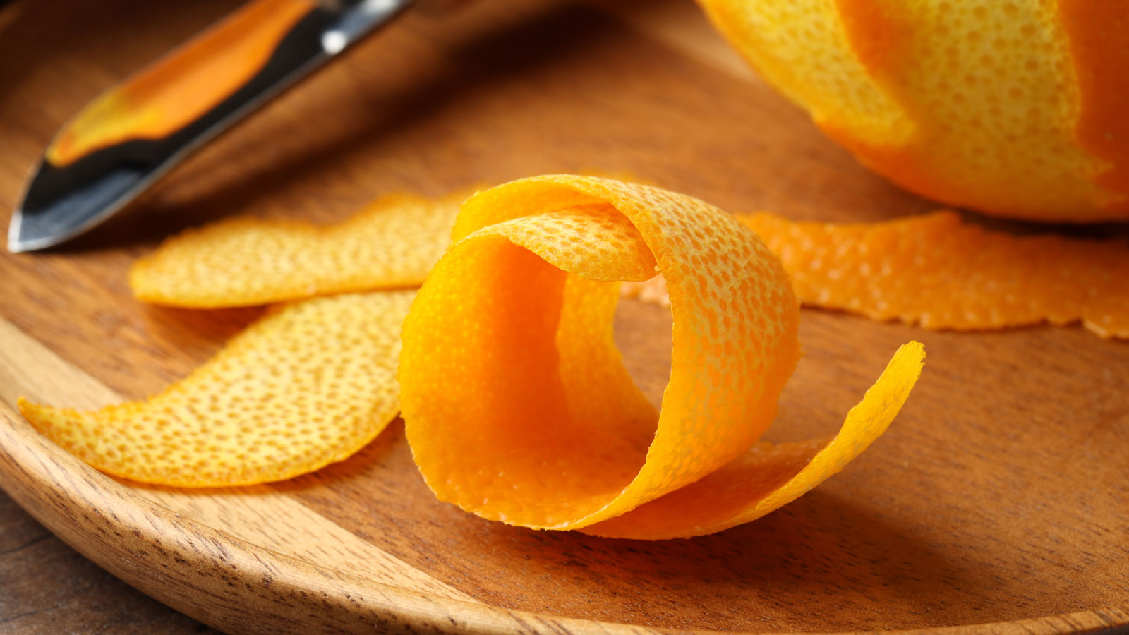 orange peel on kitchen table with knife