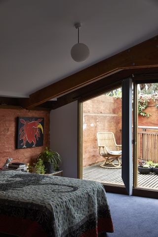 bedroom looking out at Stockroom Cottage by Architects EAT