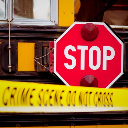 A school bus behind caution tape