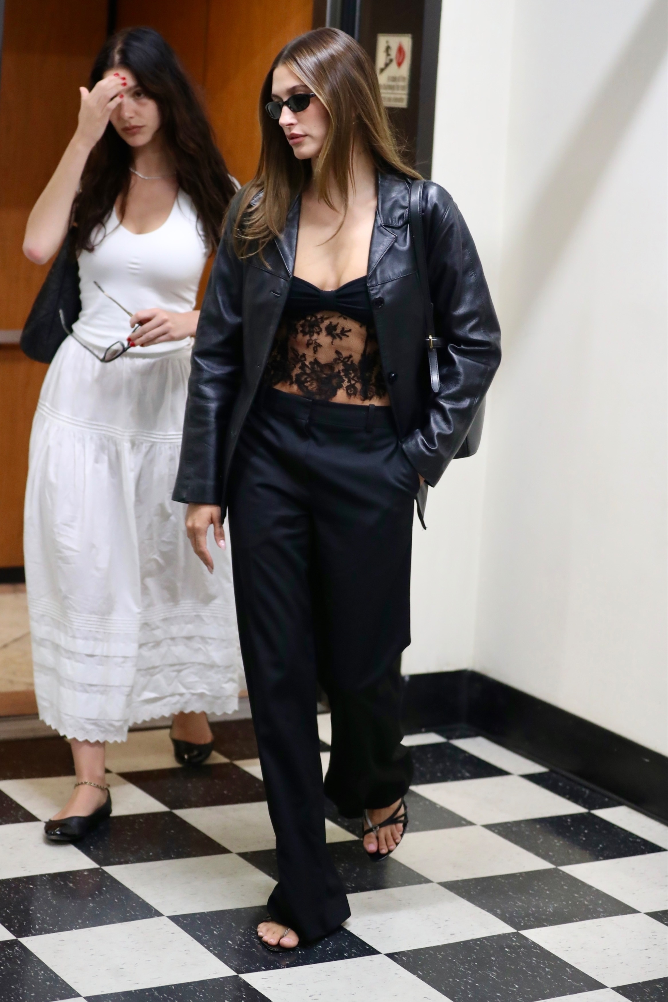 Hailey Bieber wore an all-black outfit with a lace sheer top after declaring it's lemon yellow summer.