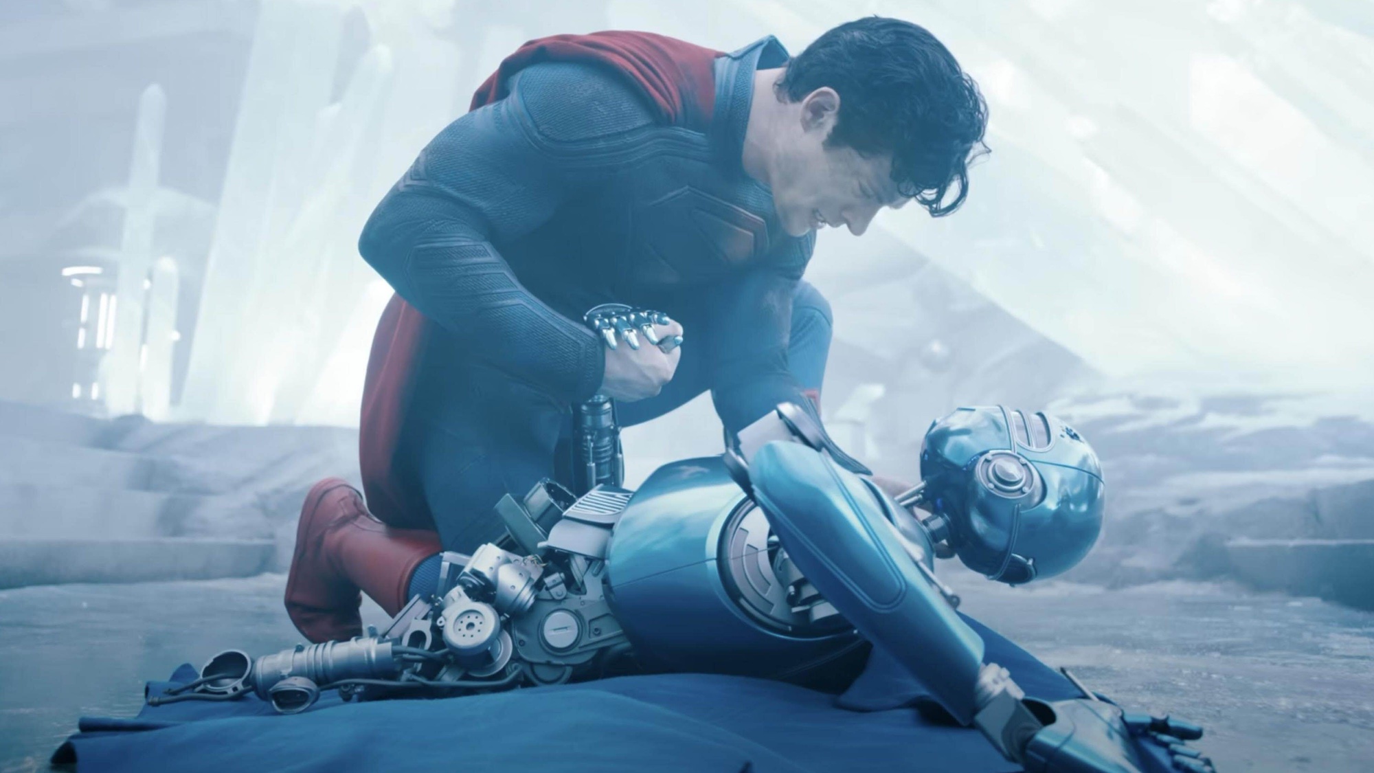 David Corenswet as Superman in Fortress of Solitude holding robot
