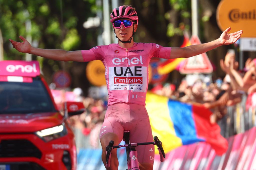 Team UAE's Slovenian rider Tadej Pogacar wearing the overall leader's pink jersey celebrates as he crosses the finish line to win the 20th stage of the 107th Giro d'Italia cycling race, 184km between Alpago and Bassano del Grappa on May 25, 2024. (Photo by Luca Bettini / AFP)