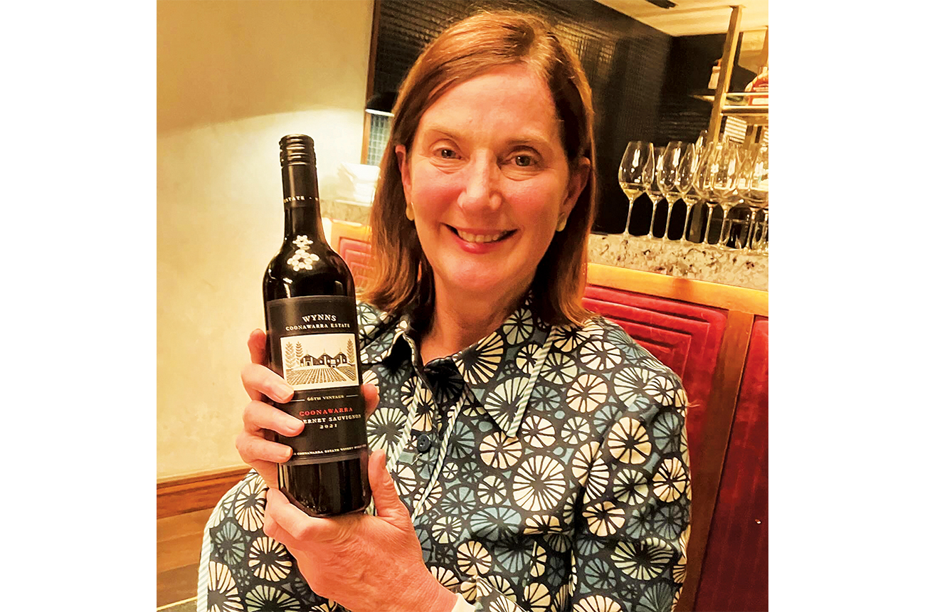 Sue Hodder holding a bottle of Wynns Black Label Cabernet Sauvignon 2021