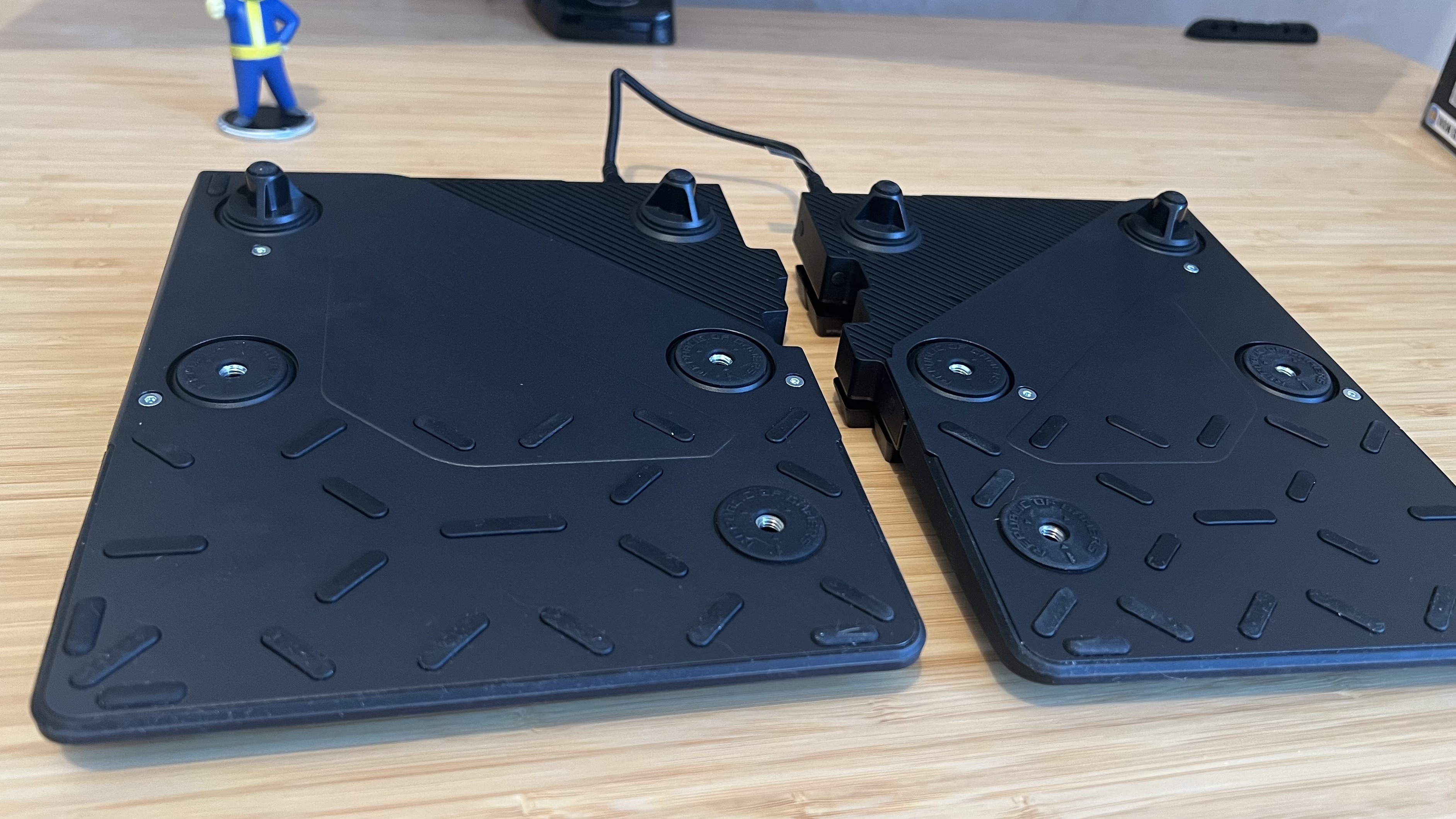 Underside of Asus ROG Falcata gaming keyboard showing wrist rest attachment and elevation feet