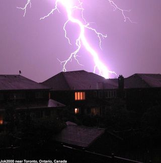 Lightning strikes over homes in Toronto, Canada.
