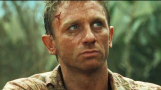 Daniel Craig glares angrily in the field in Casino Royale.
