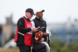 Woods with his caddie and golf bag