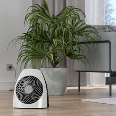 Portable electric fan heater in living room