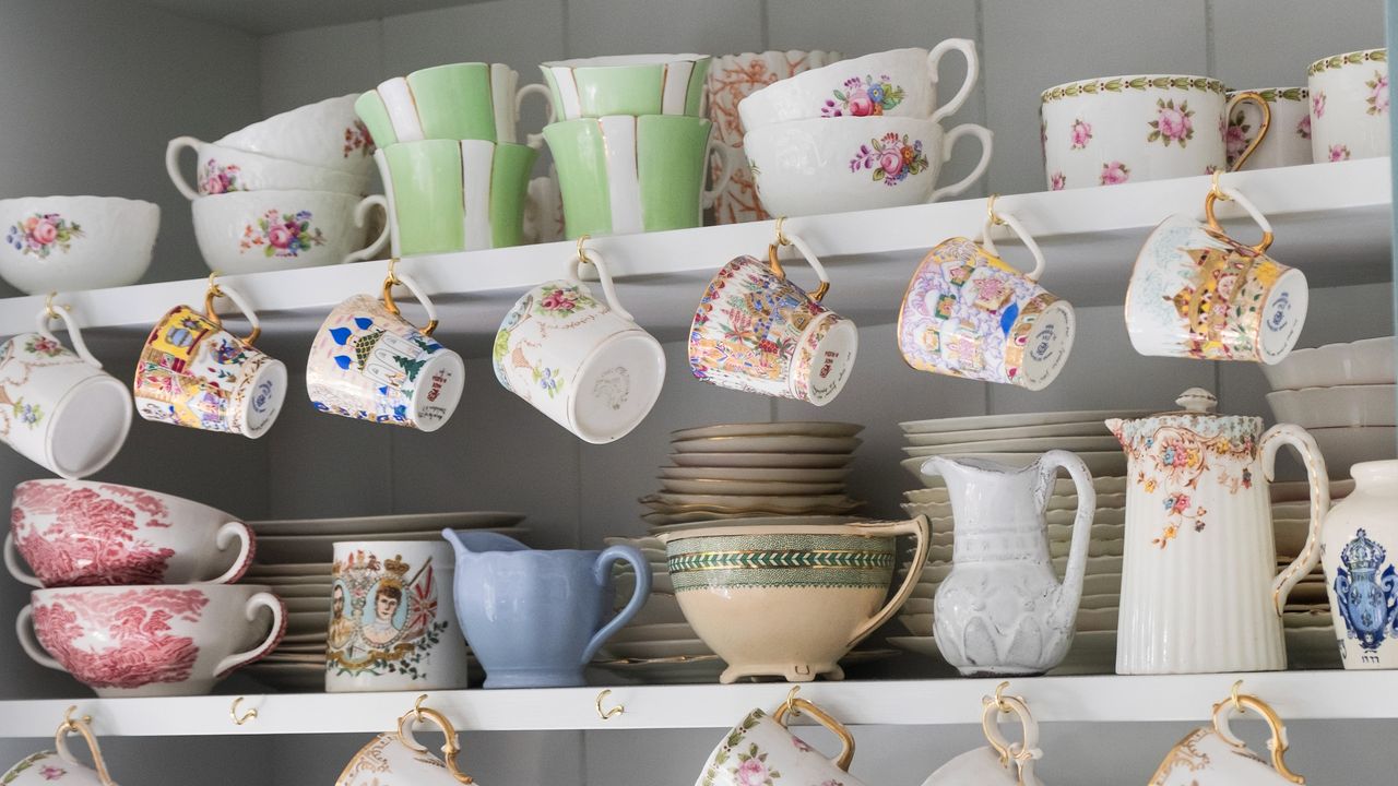 Open kitchen shelving filled with mugs and tableware