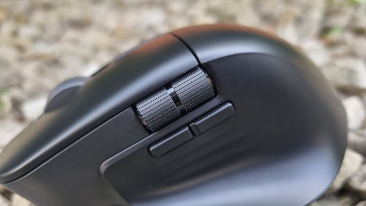A close-up shot of the Asus ProArt Mouse MD310's horizontal scroll wheel and side buttons