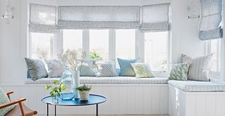 A white room with banquet seating built under a window