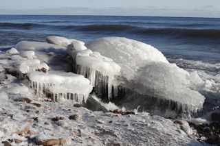 Ice covers rocks on Lake Superior. During most winters the lake is 40 to 95 percent covered with ice.