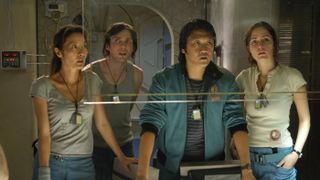 A still from the movie Sunshine, one of the best free movies to watch this week, of the main characters looking off the camera at an interface on their spaceship.