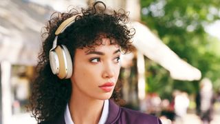 Woman wearing Bowers & Wilkins Px8 headphones.