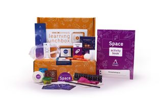 a science kit box with the various pieces laid out around it, like an activity book