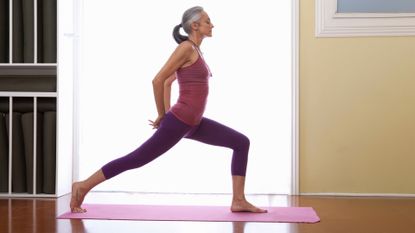 Is yoga good for you? Women standing on a yoga mat in a yoga pose