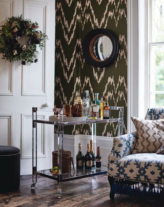 Sitting room with bar cart and wreath on door