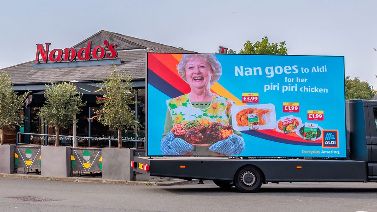 Aldi billboard outside of a Nando&#039;s restaurant