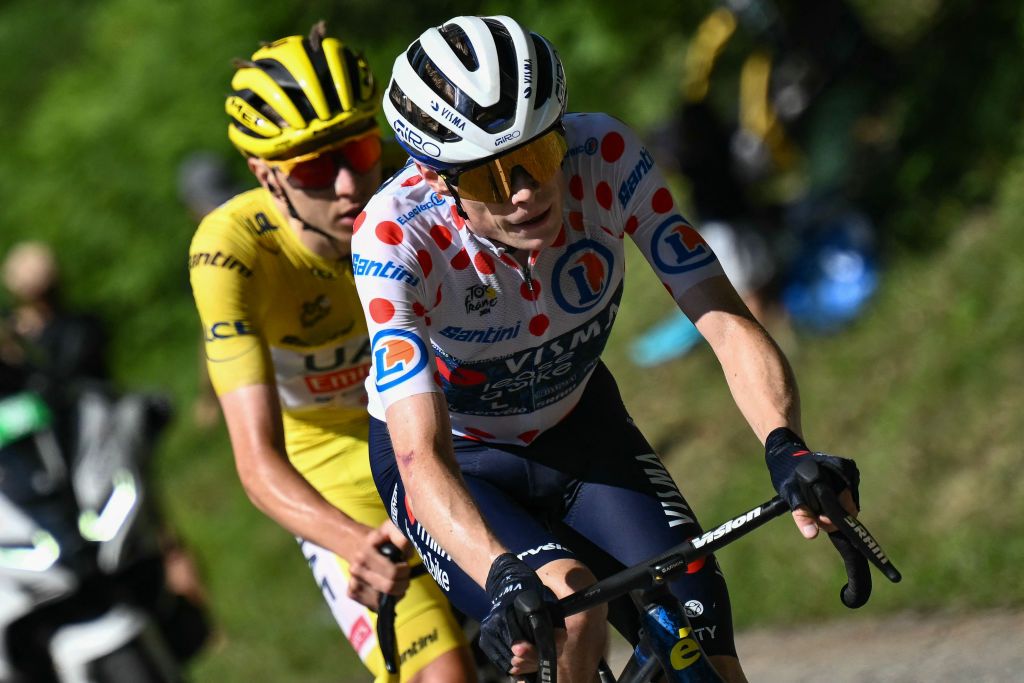 Team Visma - Lease a Bike team's Danish rider Jonas Vingegaard cycles ahead of UAE Team Emirates team's Slovenian rider Tadej Pogacar wearing the overall leader's yellow jersey in the final ascent of the Plateau de Beille during the 15th stage of the 111th edition of the Tour de France cycling race, 197,7 km between Loudenvielle and Plateau de Beille, in the Pyrenees mountains, southwestern France, on July 14, 2024. (Photo by Marco BERTORELLO / AFP)