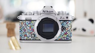 Nikon Z fc Heralbony edition, sat on a white dresser with a mirror and lifestyle accessories