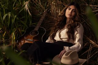 A female model with a guitar