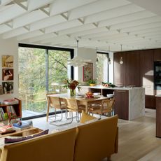 open plan kitchen-diner with living area kitchen in dark wood with marble splashbacks