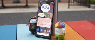 Google Pixel 7 Pro on table with toy Android Queen