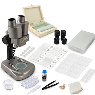 Product shot of National Geographic Dual LED Microscope with attachments spread out on surface