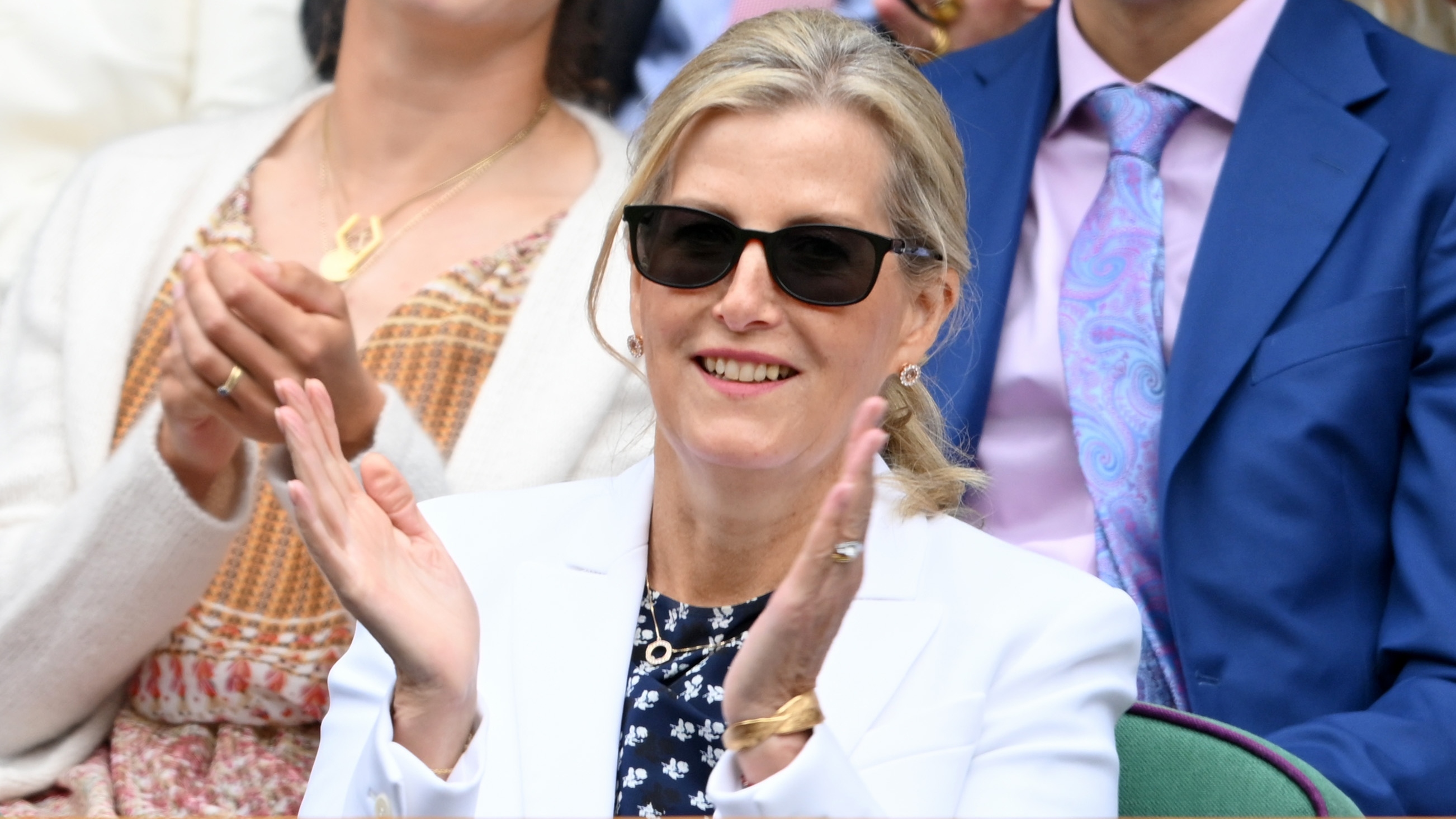 Duchess Sophie claps, wearing sunglasses, as she watches the tennis at Wimbledon 2025