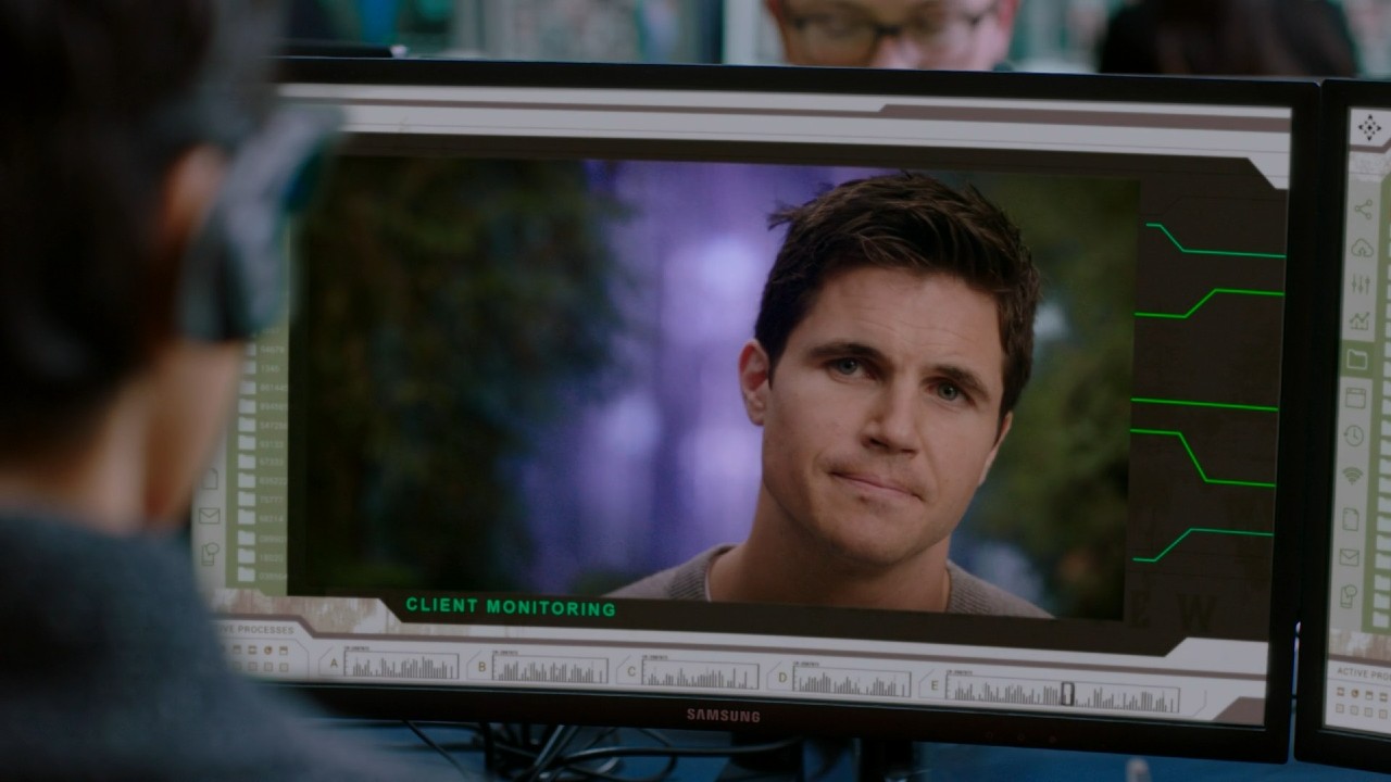 Robbie Amell on a computer in Upload.