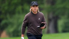 Garrick Higgo walking with his yardage book open at the PGA Championship