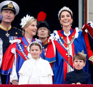 Sophie, Duchess of Edinburgh (wearing the Mantle of the Royal Victorian Order), Princess Charlotte of Wales, Princess Anne, Princess Royal, Catherine, Princess of Wales (wearing the Mantle of the Royal Victorian Order) and Prince Louis of Wales watch an RAF flypast from the balcony of Buckingham Palace following the Coronation of King Charles III & Queen Camilla at Westminster Abbey