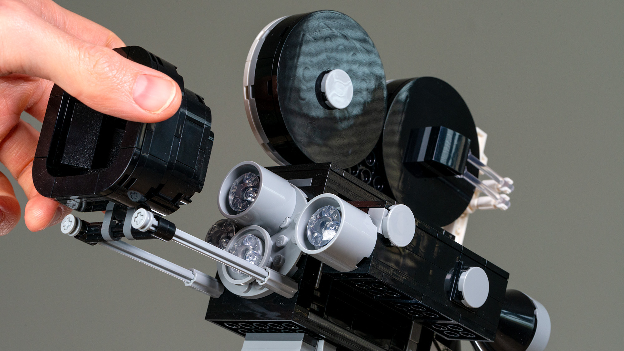 Lego Walt Disney Tribute Camera (43230) close-up of hand moving the sliding matte box to reveal the lenses