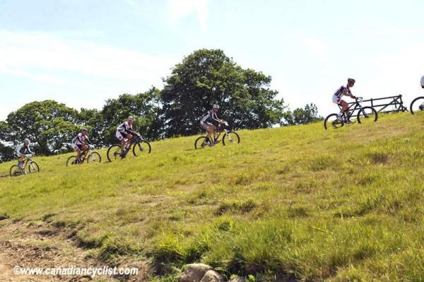 Riders climb to the highest point of the course.