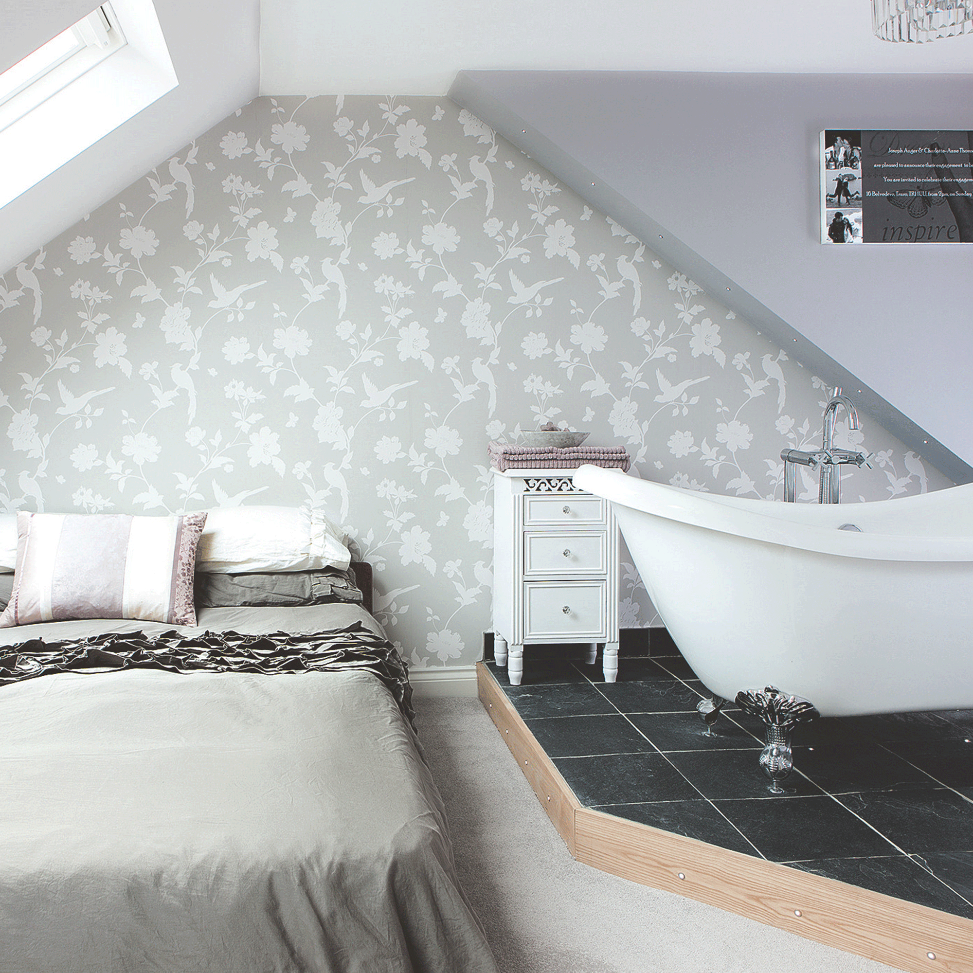 Grey bedroom with freestanding bath tub and double bed