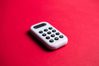 white calculator on deep red background