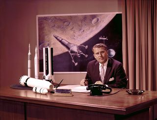Marshall Space Flight Center (MSFC) Director Dr. Wernher von Braun at his desk with moon lander in background and rocket models on his desk. Dr. von Braun served as Marshall's first director from 1960 until his transfer to NASA Headquarters in 1970.