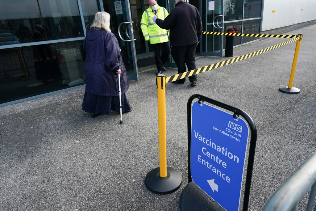 People lining up waiting for their Oxford vaccine or Pfizer vaccine