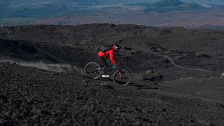 Richard Gasperotti riding down Mount Etna on a Mondraker Superfoxy mountain bike