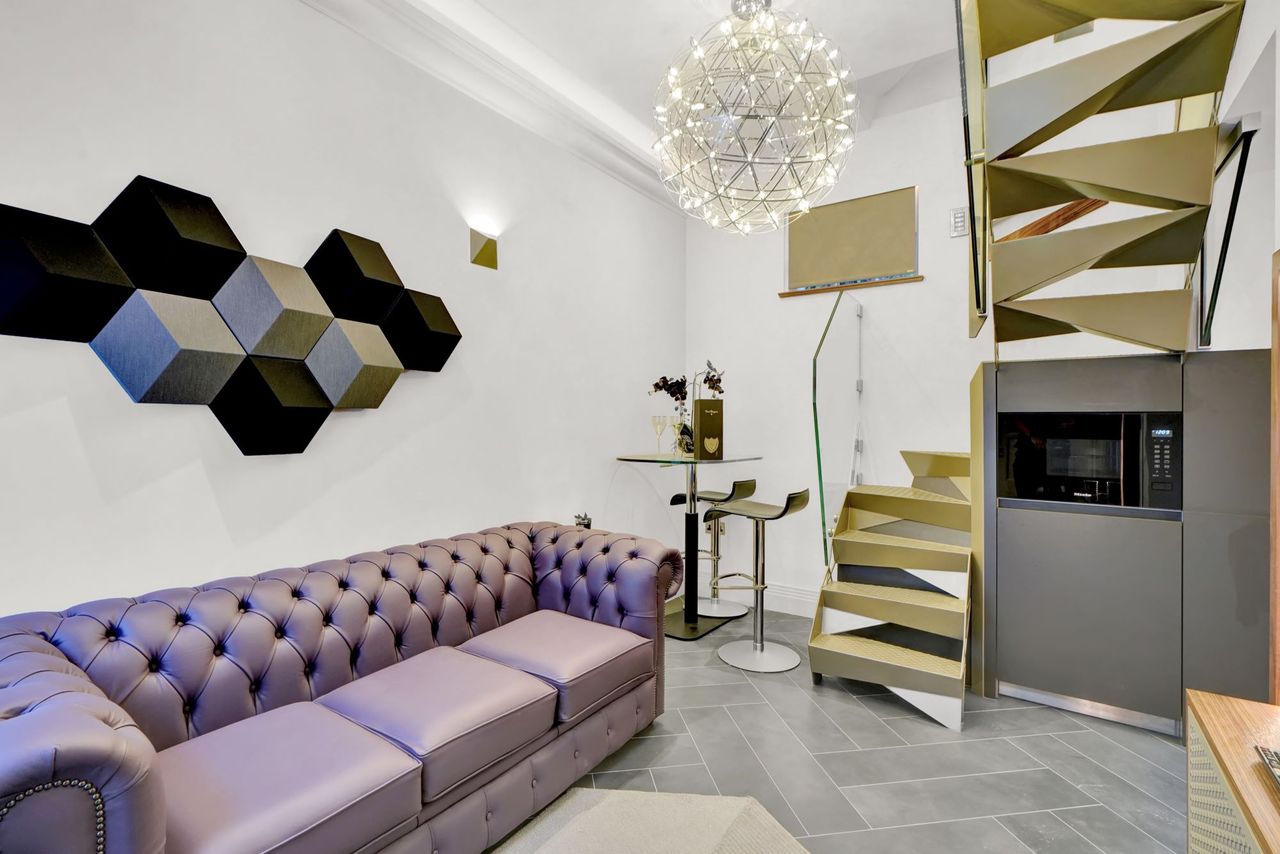 Another angle of the living room area in the small home including the metal stairwell