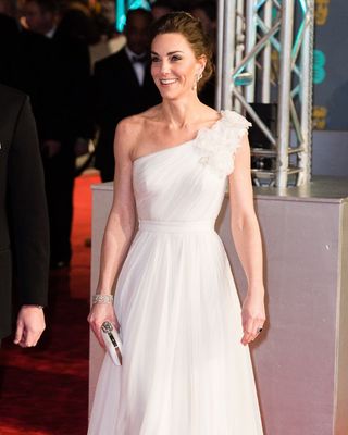 Kate Middleton wearing a white one shoulder gown with floral details