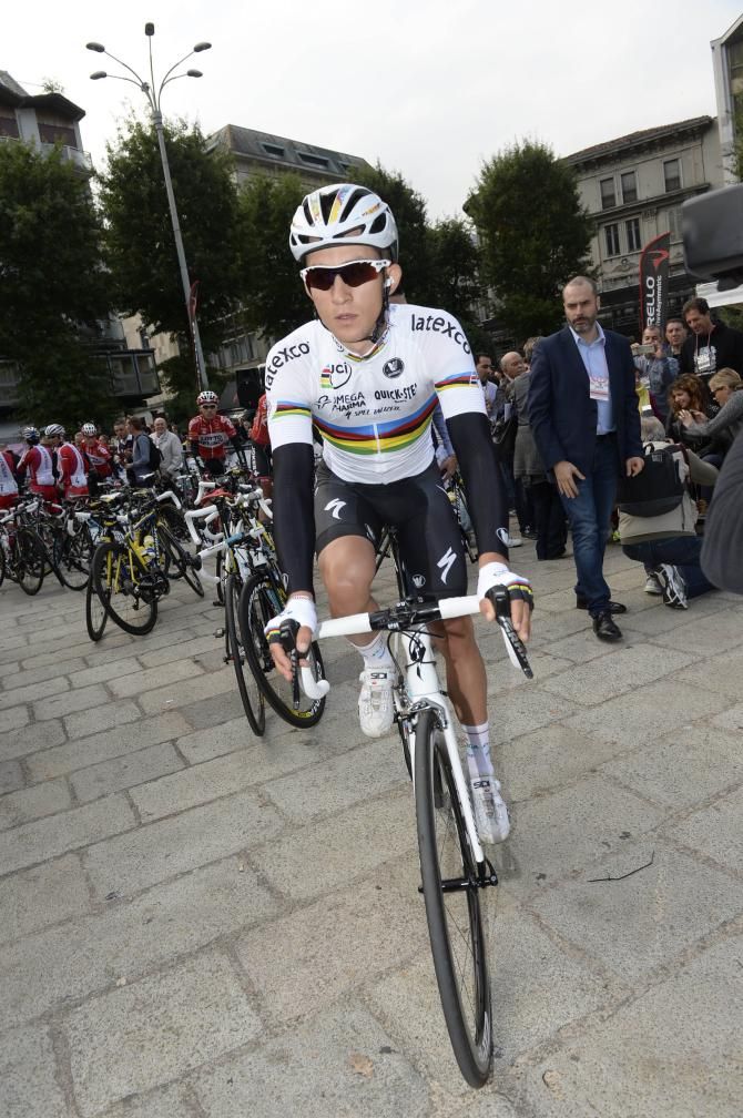 Michal Kwiatkowski rides to the start