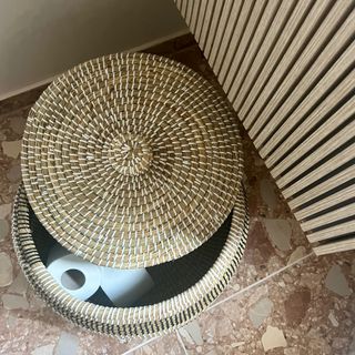 bathroom with storage basket for toilet rolls on terrazzo floor