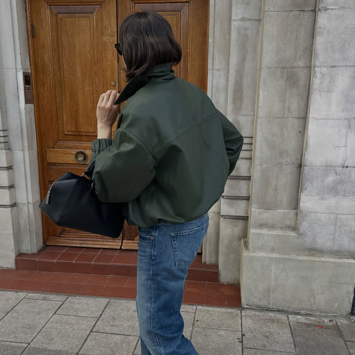 @lucyalston_ street style photo from behind wearing jeans and jacket